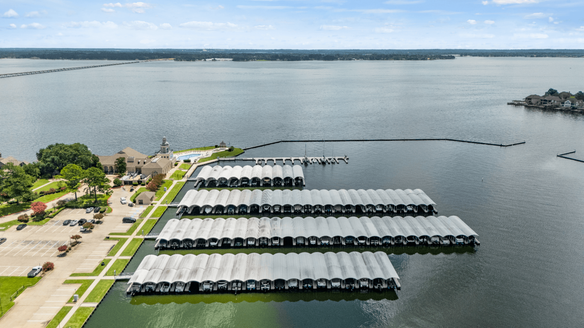 Covered boat slips with Lake Conroe beyond