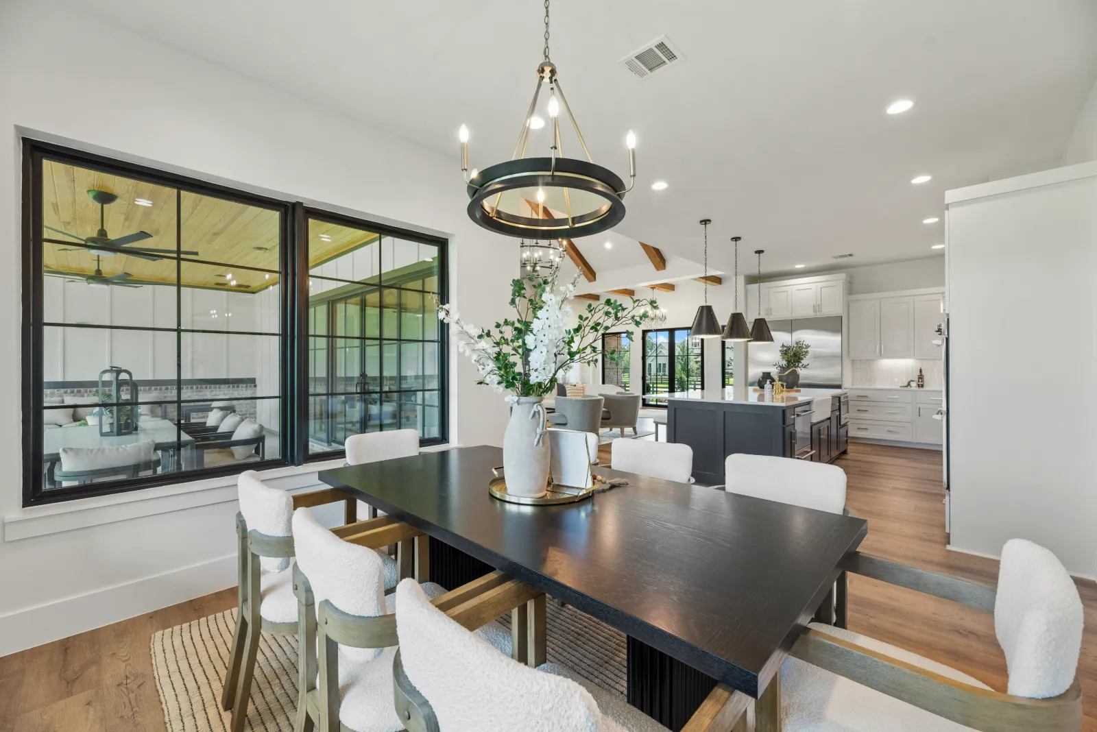 Kitchen with a custom wood range hood seen from the dining room