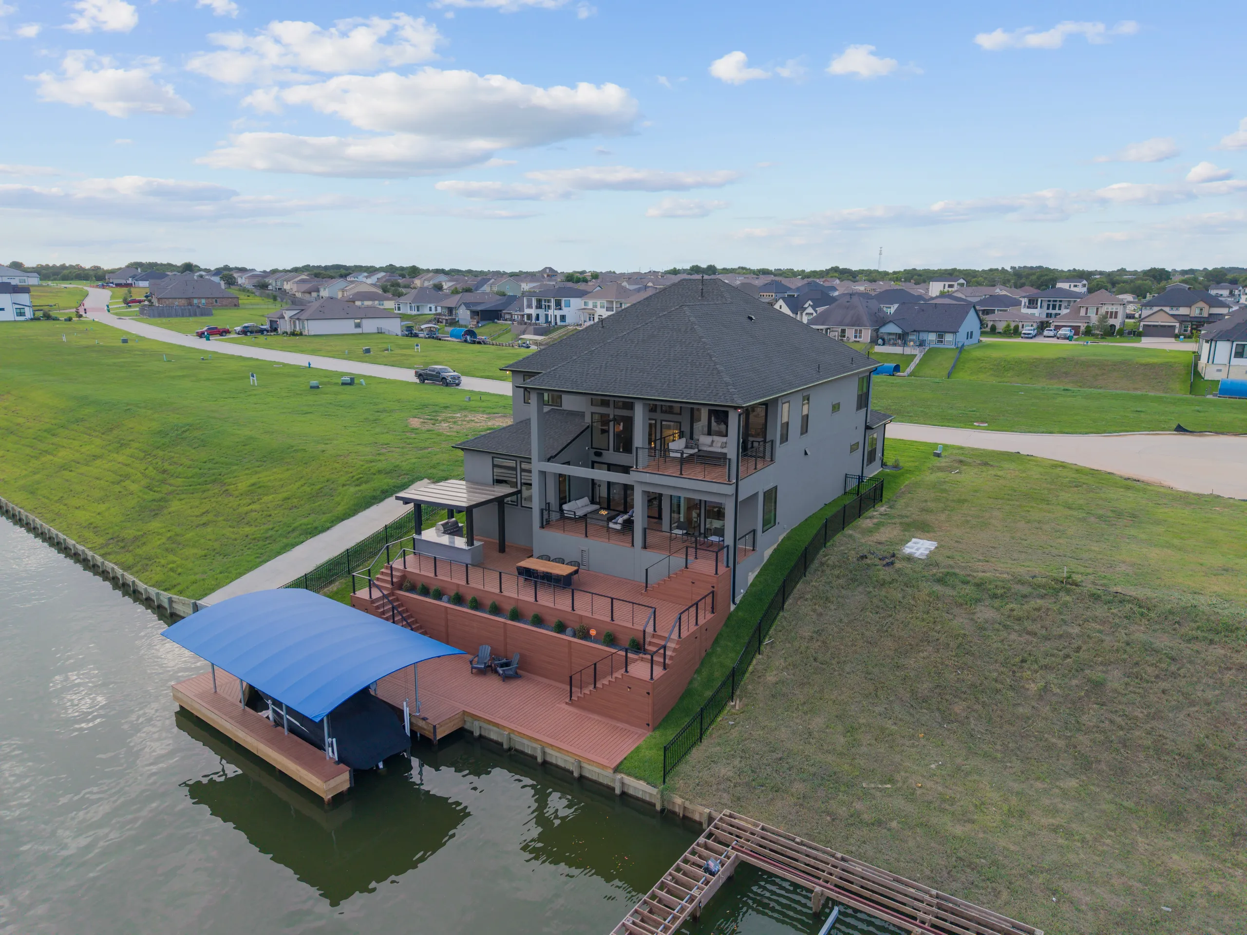 Waterfront home with multi-tiered deck and boat dock