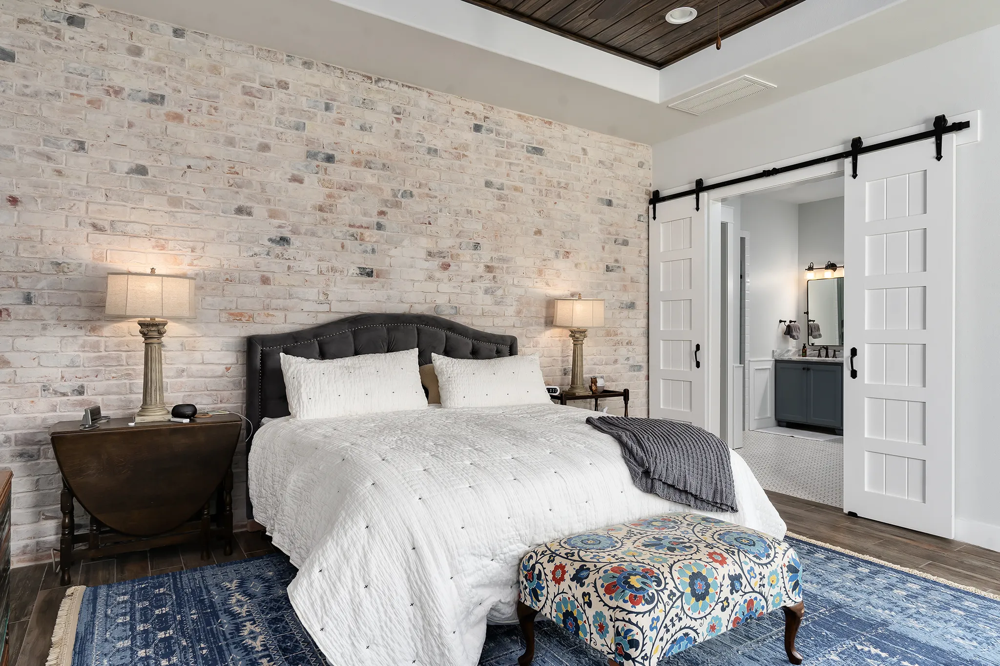 Primary suite with brick accent wall