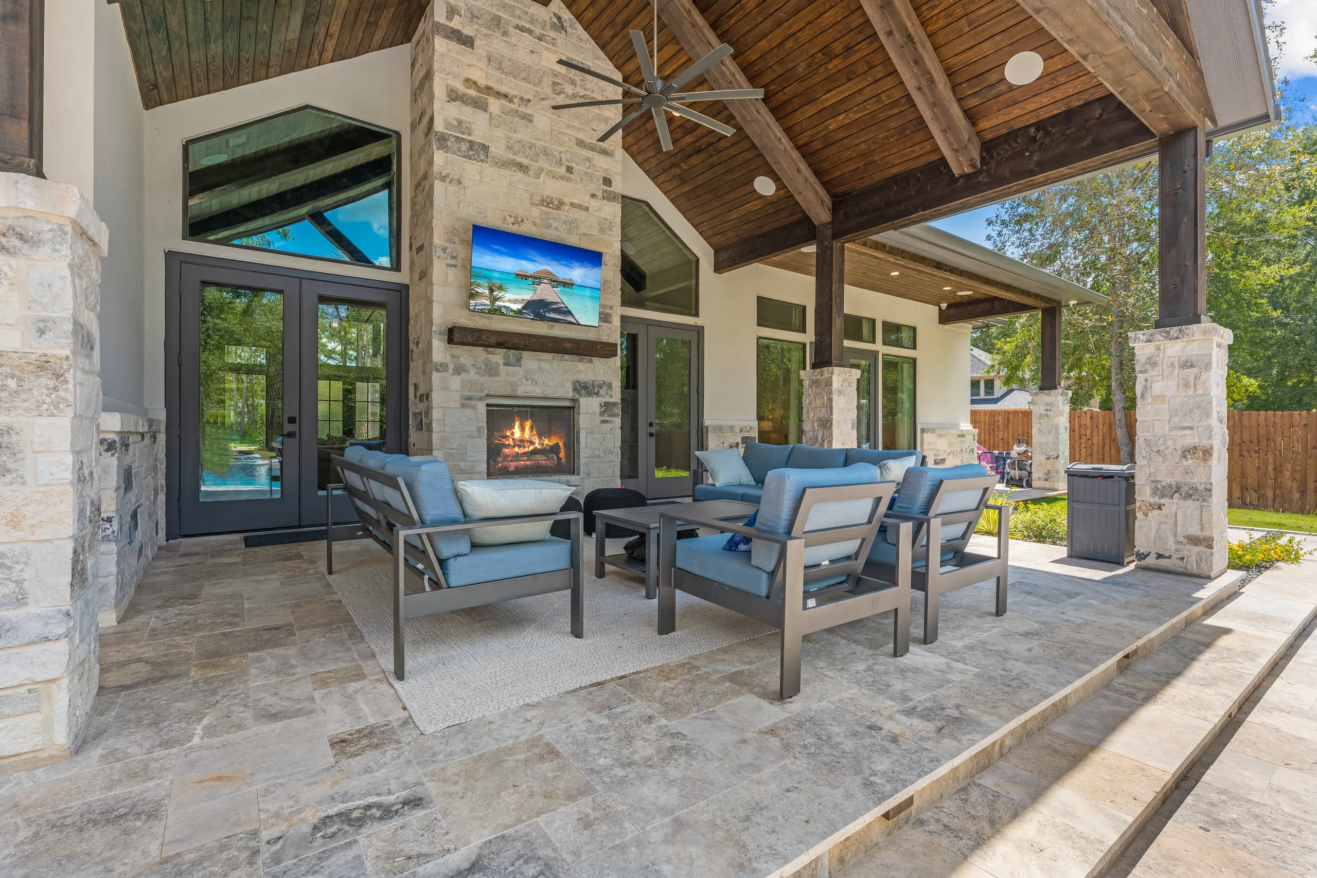 Covered outdoor kitchen with brick and copper hood
