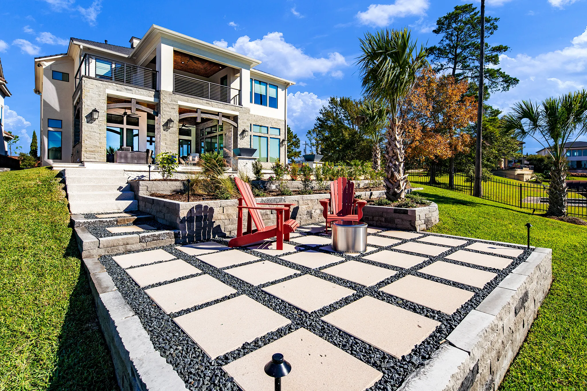 Covered outdoor living with floor-to-ceiling stone fireplace