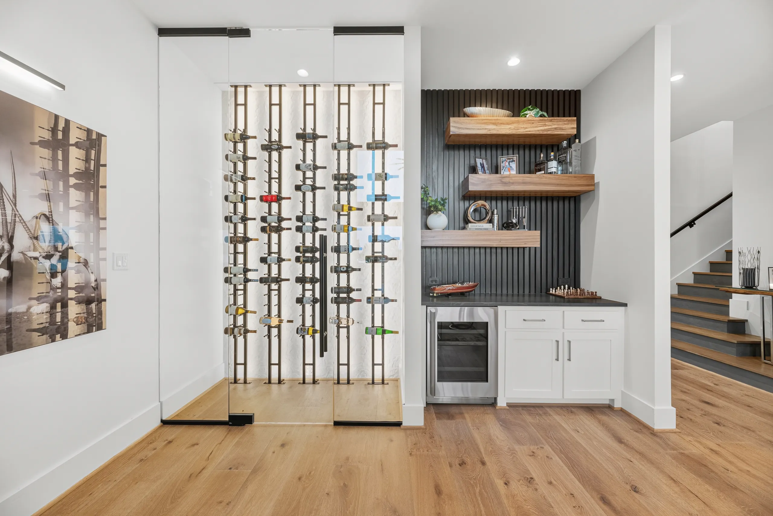 Glass-enclosed wine wall and wet bar