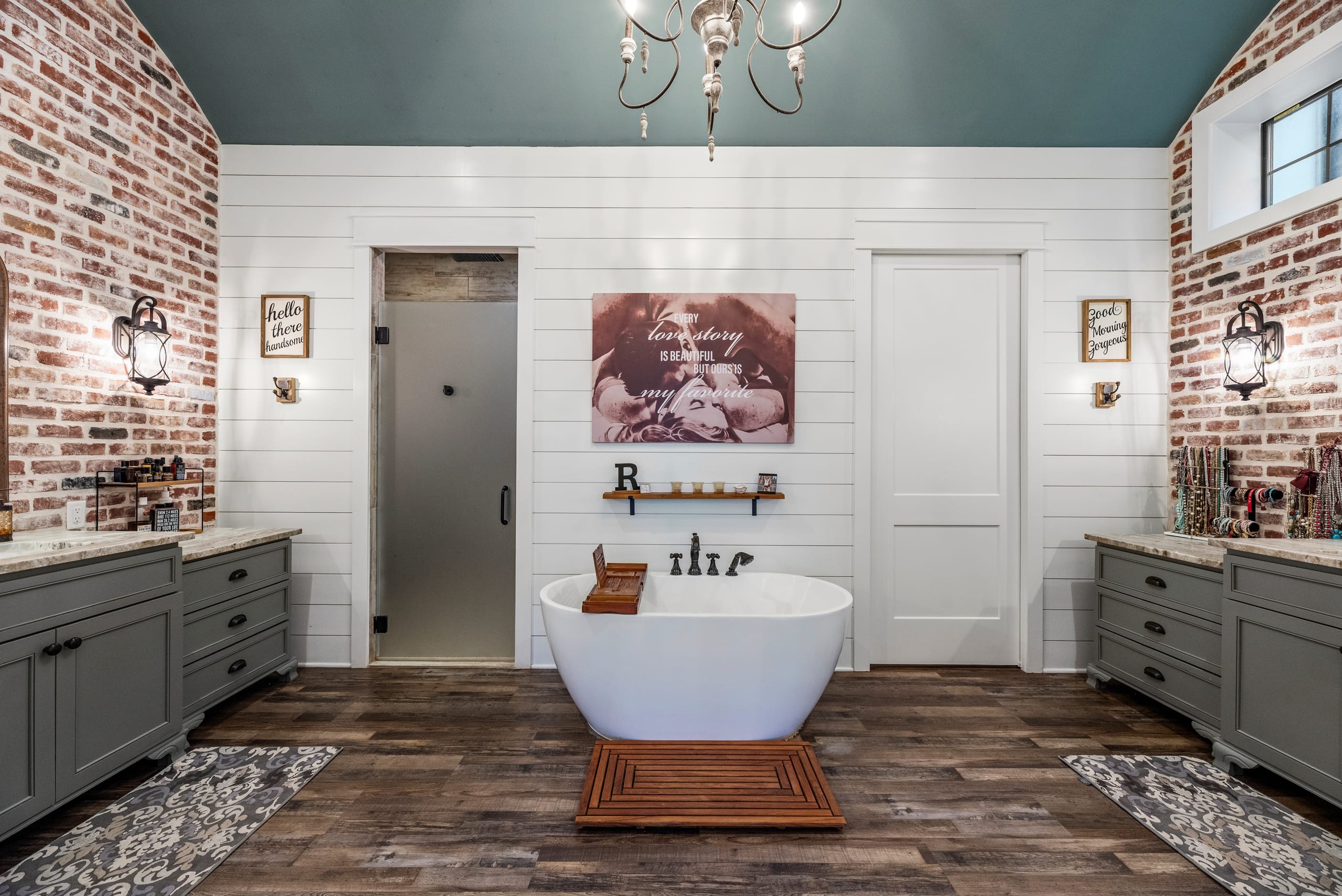 Primary bath with freestanding tub and brick walls