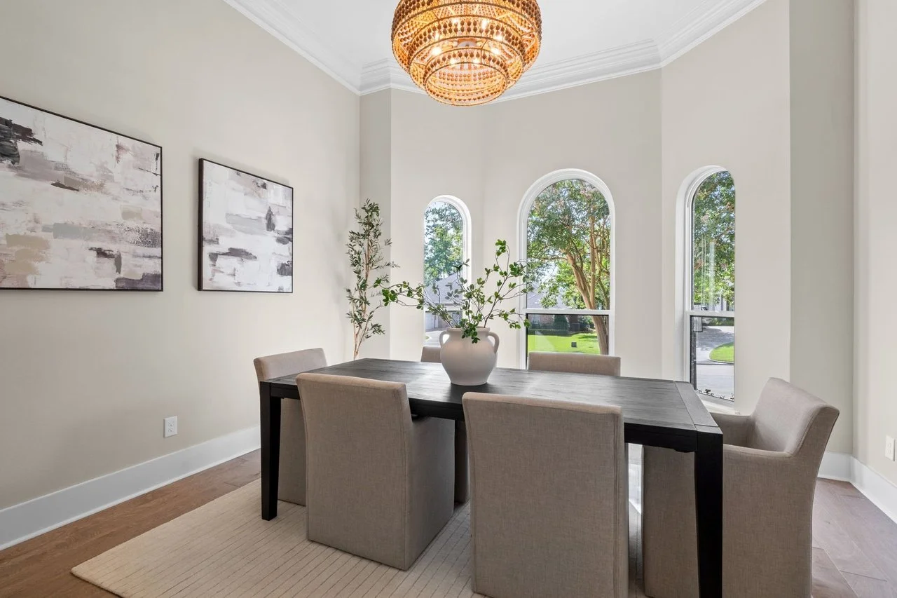 Formal dining under a statement chandelier