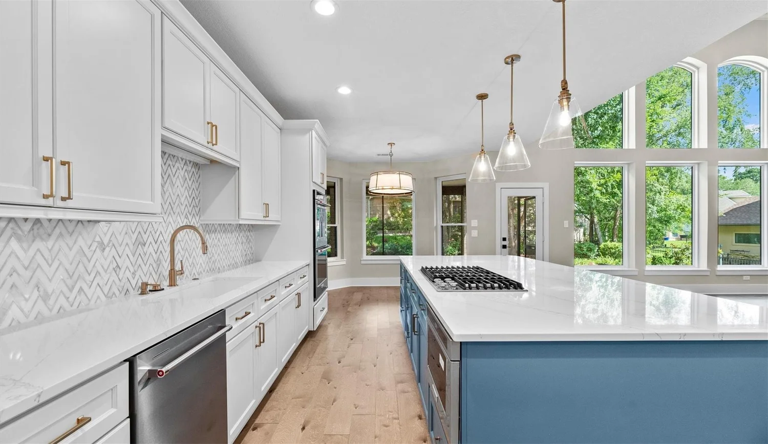 Warm wood cabinetry and brick backsplash